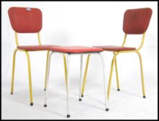 A pair of vintage 20th century metal tubular framed dining chairs along with a similar metal framed