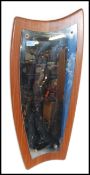 A retro 1970's atomic teak wall mirror. The frameless mirror applied to a shaped teak panel.