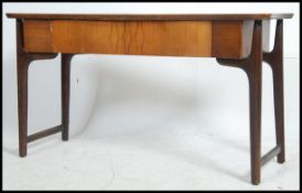 A 1970's Danish influence teak wood console hall table raised on tapered legs with return