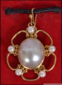 An 18ct gold baroque pearl necklace pendant. Being designed by Valerie Pritchard.