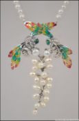 A silver freshwater pearl and plique a jour necklace in the Art Nouveau style.