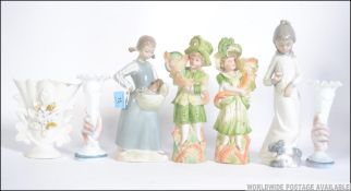 A pair of Nao ceramic figures to include girl with basket of dogs along with a pair of Bisque spill