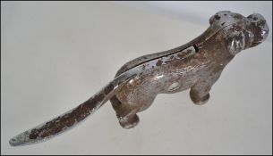An early 20th century cast metal nutcracker in the form of a dog,