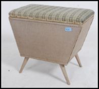 A rare and unusual mid century shaped Lloyd Loom weaved linen box of angular form raised on angled