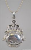 A silver ladies revolving 3 section locket set to a silver necklace chain. Total weight 15.