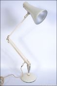 A 20th century retro Herbert Terry Anglepoise lamp in white raised on a circular base with pendant
