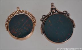 2 9ct gold and bloodstone agate pendant swivels.