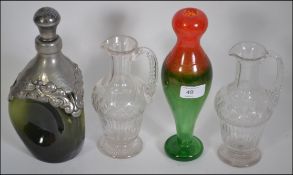 A Pair of 20th century cut glass handled decanters of small proportion with an orange and green