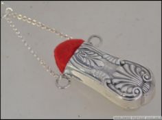 A rococo silver ( tested ) pin cushion - chatelaine adornment having red velour cushion, with chain.
