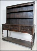 A good mid century Jacobean revival solid oak carved welsh dresser sideboard being raised on