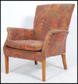 A Parker Knoll retro mid century armchair raised on tapered legs with kelim style covers having