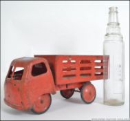 A vintage mid 20th century childrens tin lorry along with a vintage Esso One quart glass oil bottle.