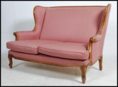 A 20th century French canape - 2 seat fauteuil sofa having a reeded show wood walnut frame with