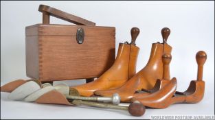 A vintage mid 20th century shoe shine box with some contents along with wooden and metal shoe /