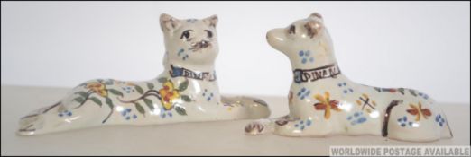 A pair of late 19th century early 20th century hand painted glazed French art pottery / Faience cat