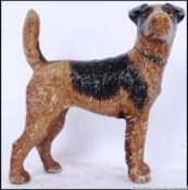 A vintage style, 20th century cast iron doorstop of a brown & black sheep dog. 16cm long.