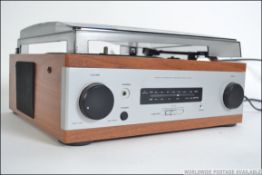 A contemporary 20th century stereo integrated turntable amplifier tuner, with a smoked plastic lid.