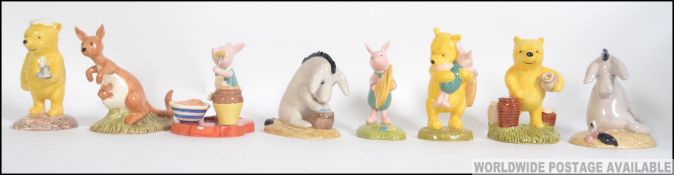 A good collection of 8 Royal Doulton Winnie The Pooh figurines to include A big noise for little