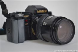A good vintage Minolta SLR camera complete with lens and accessories in the bag ( see multiple