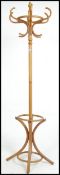 A 20th century Thonet style blond bentwood hat stand having shaped legs with hooks atop raised on