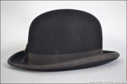 A vintage early 20th century bowler hat by Hawkes & Co of Savile Row London with a silk lining