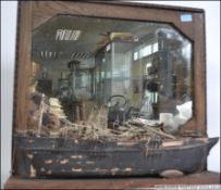 An unusual 20th century wall mirror with shelf having applied hull - shipwrecked boat being scratch