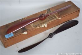 2 unusual vintage hand made wooden aeroplane propellers having bored centres. Complete in the box.