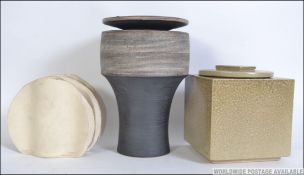 A group of three pieces of Studio pottery to include a square lidded pot,