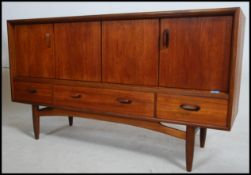 a vintage / retro teak wood mid 20th century G Plan sideboard having a pair of Bi - Fold doors