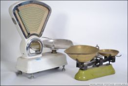 A pair of vintage white enamel Avery Grocer's shop scales along with a pair of vintage Avery