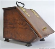 A 19th century elm and brass coal scuttle.