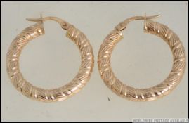 A pair of 9ct / 375 hallmarked gold rope twist large creole earrings having wishbone clasp.