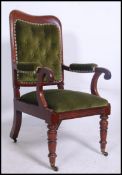 A Victorian / Regency mahogany armchair being raised on turned legs with shaped elbow rests.