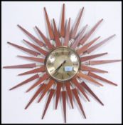 A vintage 1950's teak and gilt metal sunburst clock with gilt dial, notation for Anstey & Wilson.