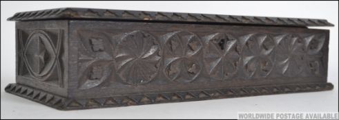 A 19th century carved Jacobean oak box - table top chest with hinged lid and a sectional lined