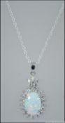 A contemporary silver opal and cz stone pendant necklace set to a fine linked silver chain.