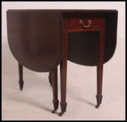 A 19th century mahogany drop leaf dining table table with satinwood inlay and cross banding on