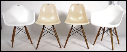 A collection of 4 Eames style DSW chairs. The armchairs in white, dining chairs in yellow.
