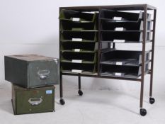 A vintage / retro 20th century industrial metal framed filing drawers having a series of plastic