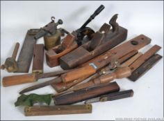 A collection of vintage woodworking tools to include several levels, box plane,