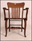 A good 1920's solid oak Industrial office armchair / chair raised on a a shaped leg base with