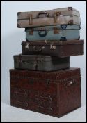 A stack of vintage suitcases and trunks etc to include mid century and early 20th century together