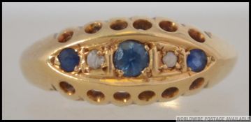 An Edwardian 18ct gold sapphire and diamond ring.