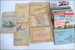 A collection of vintage early 20th century cigarette cards along with some vintage tea cards