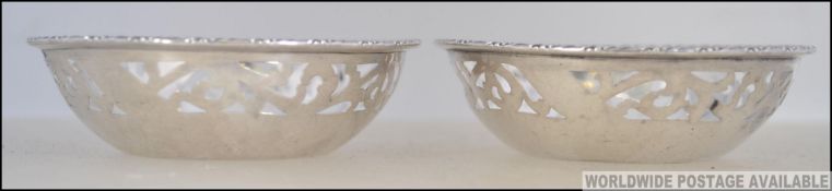A pair of silver fret worked hallmarked peanut dishes.