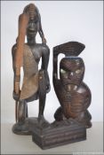 A collection of wooden ethnic items to include two Maori pieces along with an African carving.