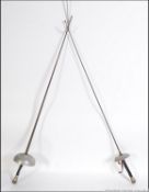 A pair of 20th century fencing foils / epee's swords. With aluminium guards.