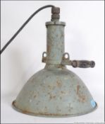 A vintage industrial 20th century metal cased Maxlume hand held spot lamp with a wooden handle and