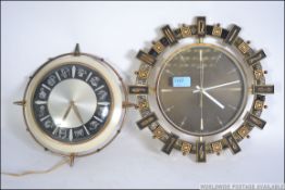 A vintage mid century 1950's Metamec zodiac wall clock together with a Metamec retro Aztec wall