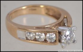 A 9ct yellow gold and diamond ring with central stone of approx 75pnts and 80 pnts to the shoulders.